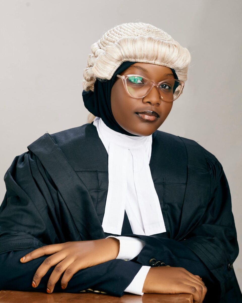 Portrait of a confident female lawyer wearing a wig and gown in a studio setting in Kano, Nigeria.